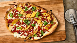 Overhead shot of peaches flatbread with julienne pepperoni